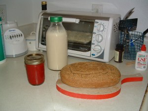 From left, strawberry jam, soymilk, quinoa-brown rice bread, with okara toasting in the toaster oven